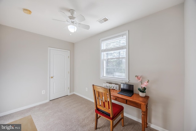 office space with a ceiling fan, visible vents, baseboards, and carpet floors