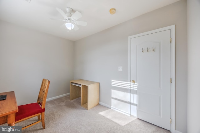 office area with light carpet, baseboards, and a ceiling fan