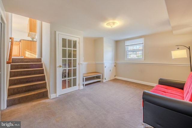 living area featuring stairway, baseboards, and carpet floors