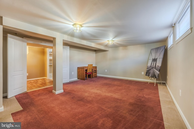 interior space with baseboards and carpet flooring