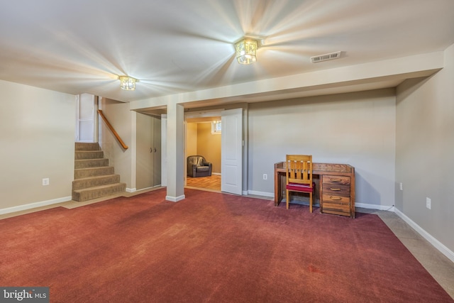 finished basement featuring visible vents, stairway, baseboards, and carpet floors