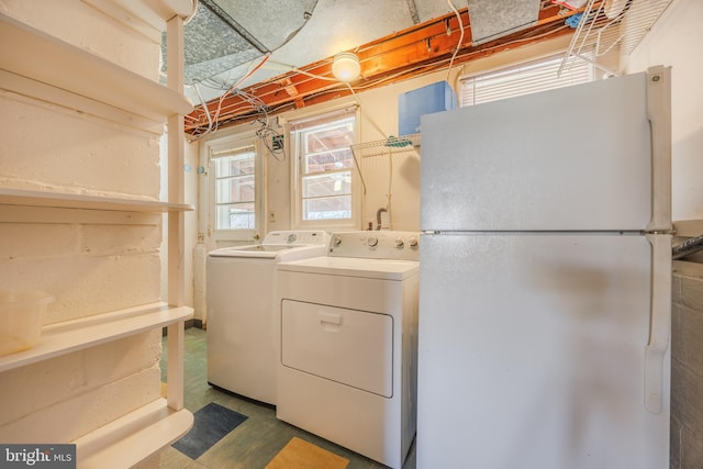 laundry room with separate washer and dryer and laundry area