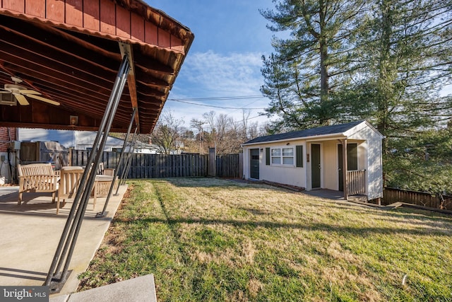 view of yard with an outdoor structure and a fenced backyard