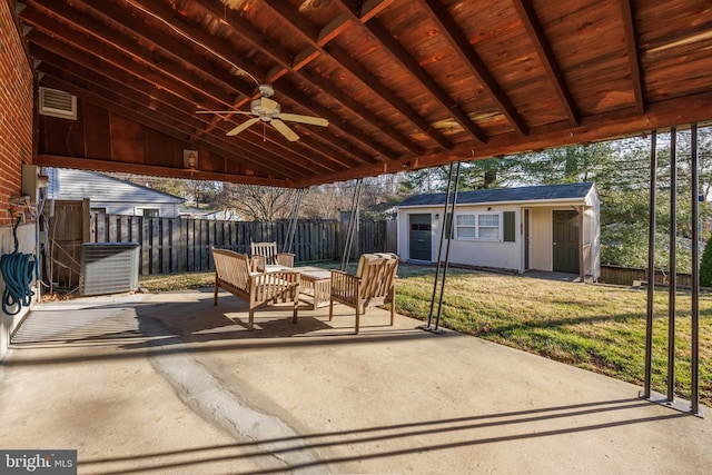 view of patio / terrace with an outdoor structure, a fenced backyard, central AC, and ceiling fan