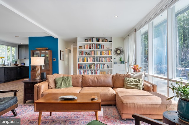 living area with recessed lighting and light wood-style floors