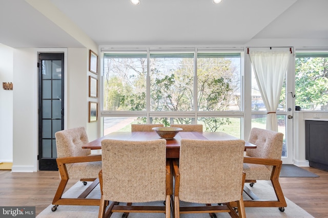 dining area with floor to ceiling windows, recessed lighting, wood finished floors, and baseboards