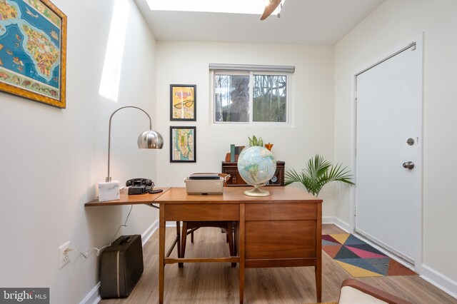 office featuring baseboards and wood finished floors