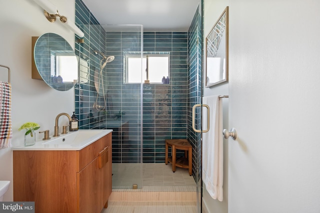 bathroom featuring tile patterned floors, vanity, a shower stall, and toilet