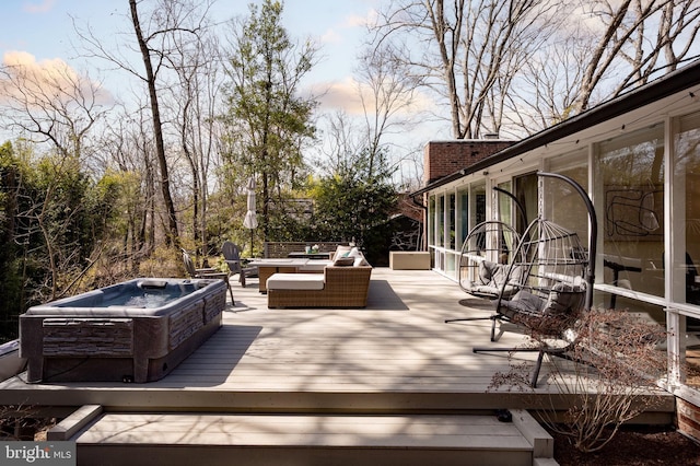 wooden deck featuring outdoor lounge area and a hot tub