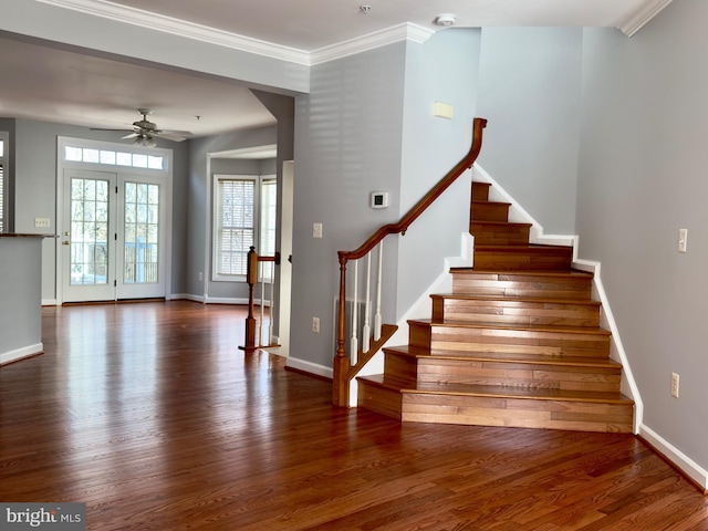 stairway featuring baseboards, a ceiling fan, wood finished floors, and crown molding