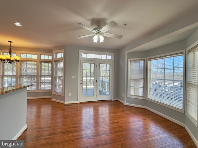 interior space with ceiling fan with notable chandelier, recessed lighting, baseboards, and dark wood-style flooring