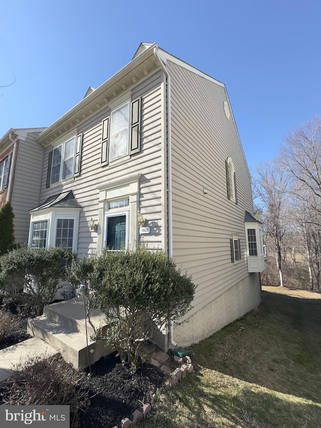 view of side of property with a yard