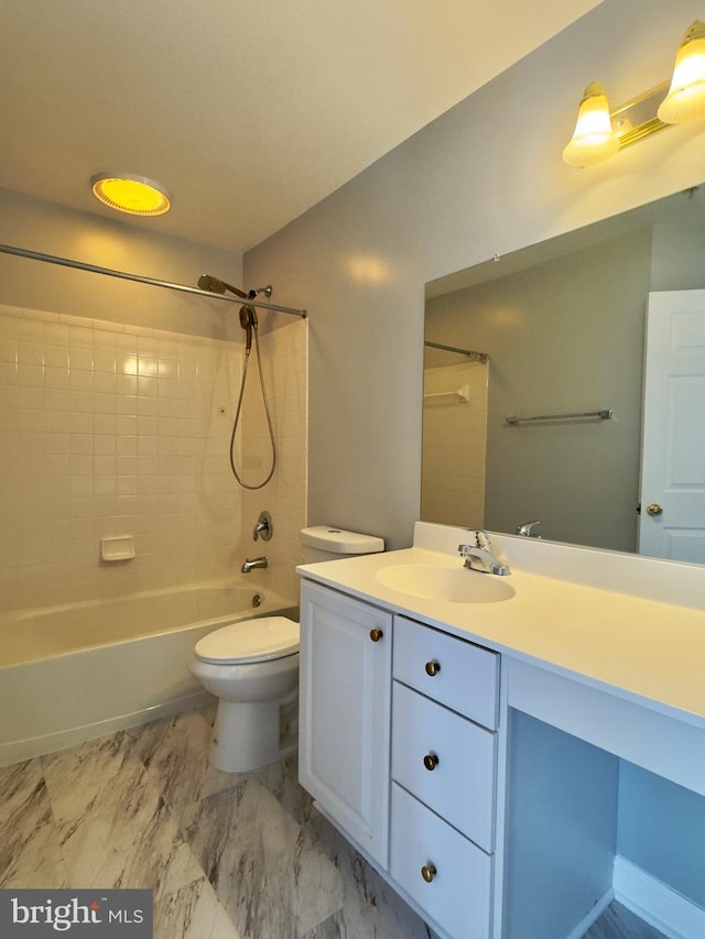 bathroom with vanity, toilet, washtub / shower combination, and marble finish floor