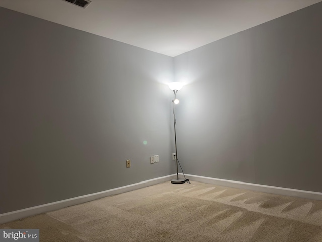 empty room with light carpet and baseboards