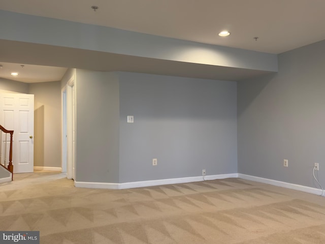 basement featuring recessed lighting, baseboards, light carpet, and stairs