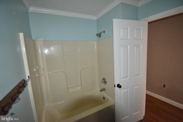 full bath featuring  shower combination, crown molding, baseboards, and wood finished floors