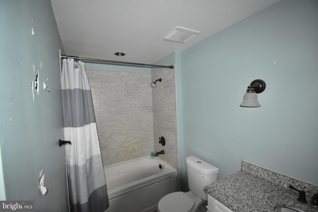 full bathroom with vanity, toilet, visible vents, and shower / tub combo with curtain