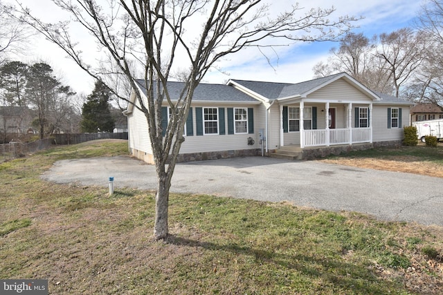 view of front of home with crawl space, aphalt driveway, covered porch, and fence