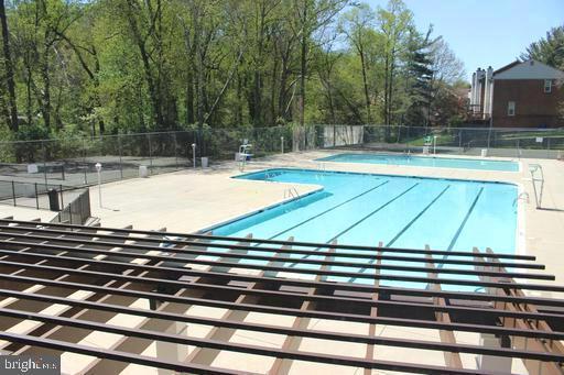 pool featuring a patio area and fence