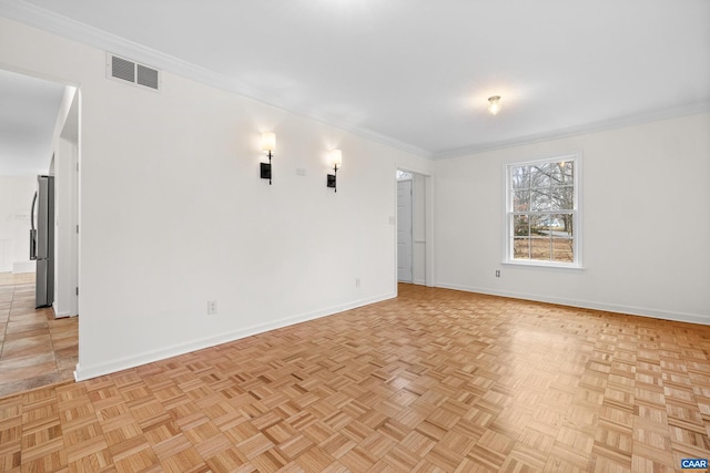 empty room with visible vents, baseboards, and ornamental molding