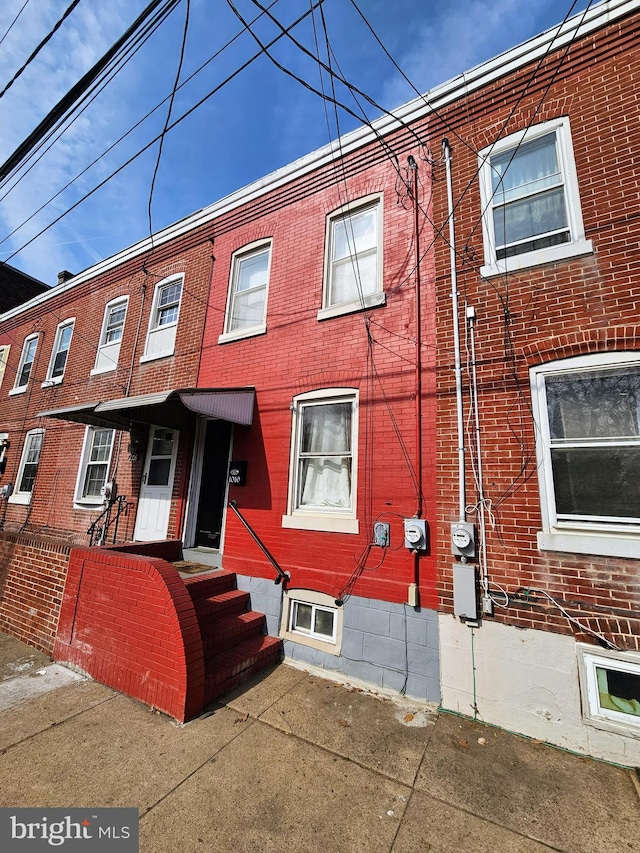 view of property with brick siding