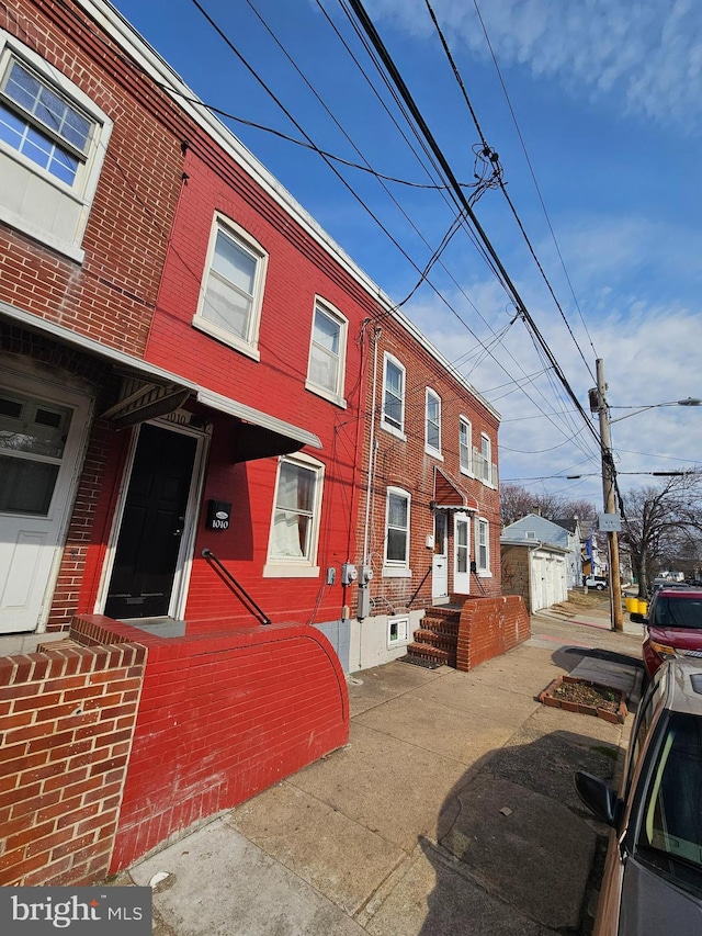 multi unit property with a detached garage and brick siding