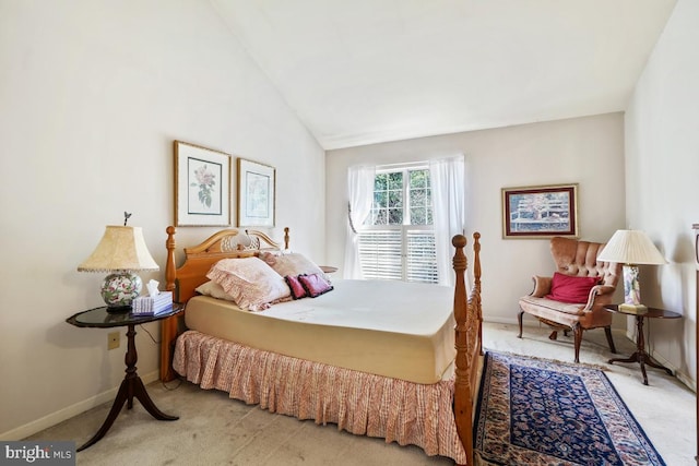 carpeted bedroom featuring lofted ceiling and baseboards