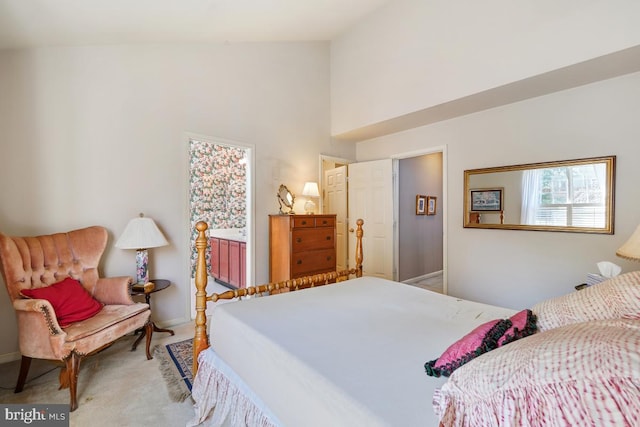 bedroom with carpet flooring and high vaulted ceiling