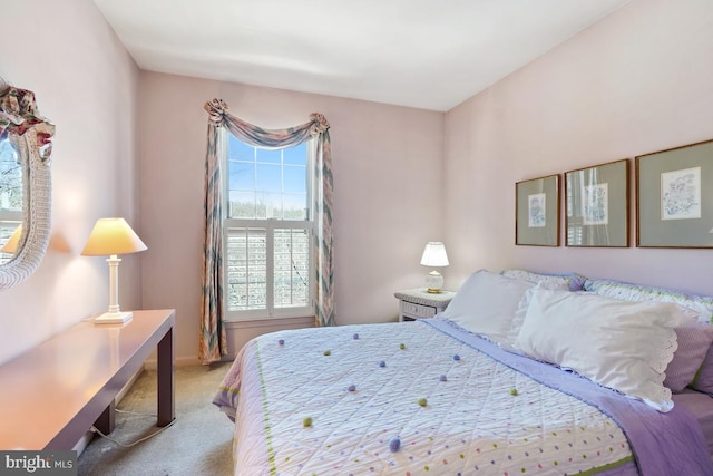 bedroom with carpet flooring and baseboards