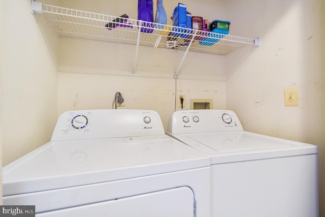 washroom featuring washing machine and clothes dryer and laundry area