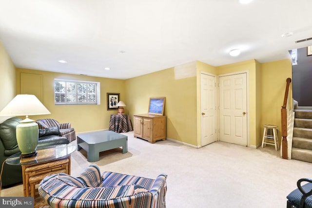 living room featuring stairway, light colored carpet, baseboards, and visible vents