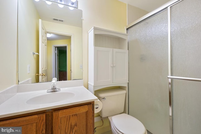 bathroom with visible vents, a stall shower, toilet, and vanity