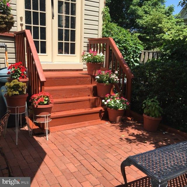 wooden deck featuring french doors and a patio