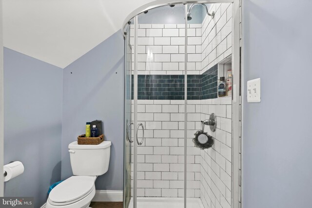 full bath with a shower stall, toilet, and baseboards