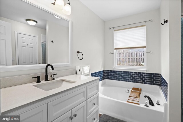 bathroom featuring vanity and a garden tub