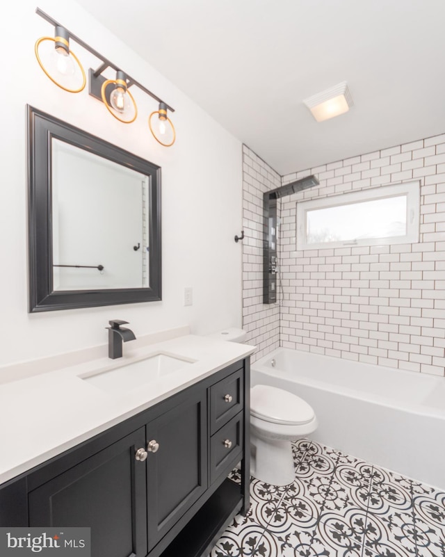 full bathroom featuring tile patterned flooring, toilet, vanity, and shower / washtub combination