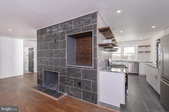 kitchen featuring light stone countertops, open shelves, recessed lighting, appliances with stainless steel finishes, and white cabinetry