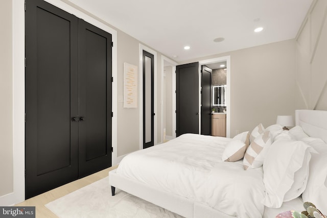 bedroom with recessed lighting and wood finished floors