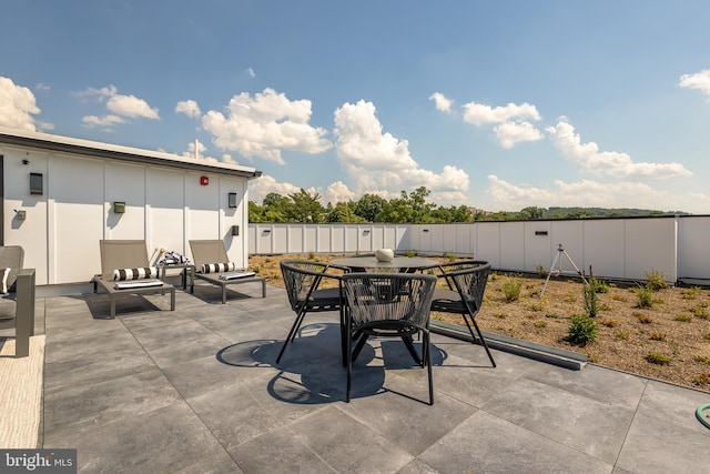 view of patio / terrace featuring outdoor dining space and fence