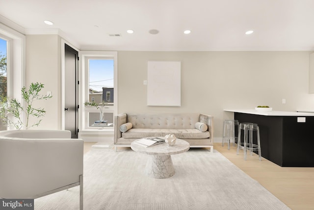 living room with wood finished floors, recessed lighting, a healthy amount of sunlight, and visible vents