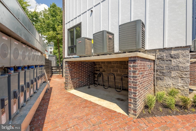 view of patio with central AC and fence