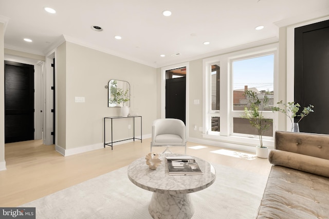 sitting room with recessed lighting, light wood-style flooring, baseboards, and ornamental molding