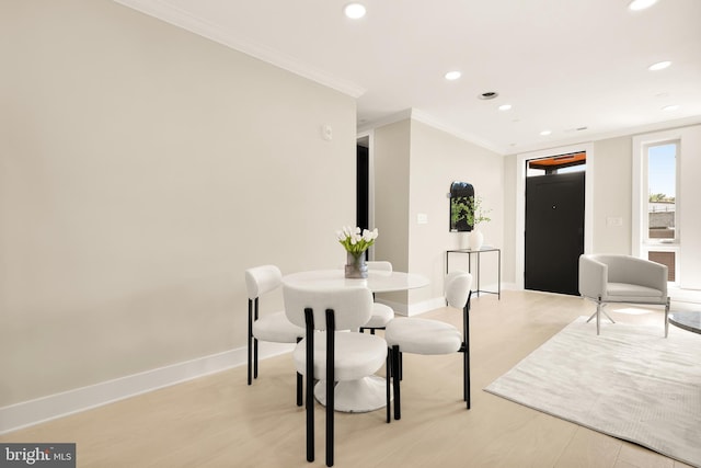 dining room with light wood finished floors, recessed lighting, baseboards, and ornamental molding