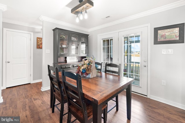 dining room with visible vents, baseboards, ornamental molding, french doors, and dark wood-style flooring