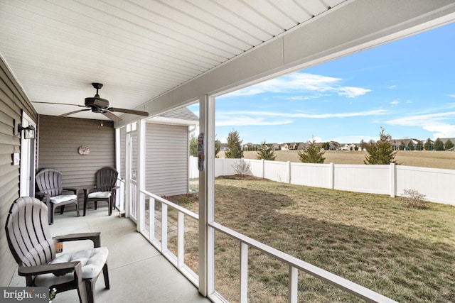 view of patio featuring ceiling fan and fence