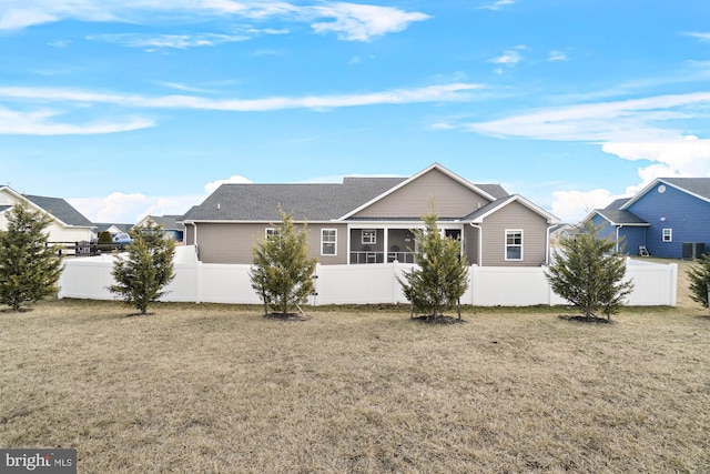 exterior space with a front yard, fence private yard, and a sunroom