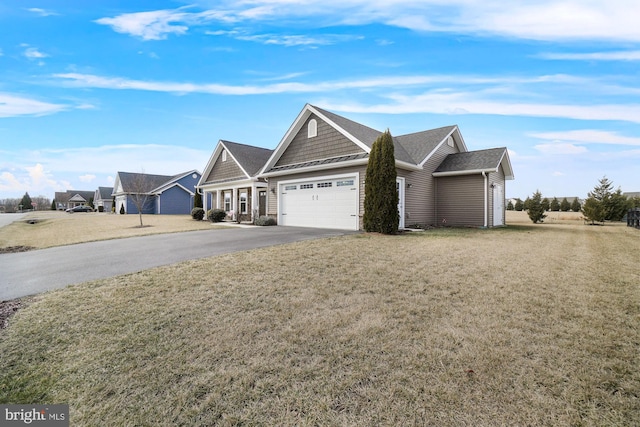 view of front of property with a garage, driveway, and a front lawn