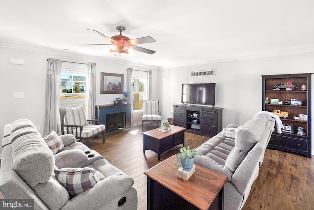 living area with crown molding and wood finished floors