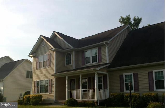 craftsman inspired home featuring a porch and a front yard