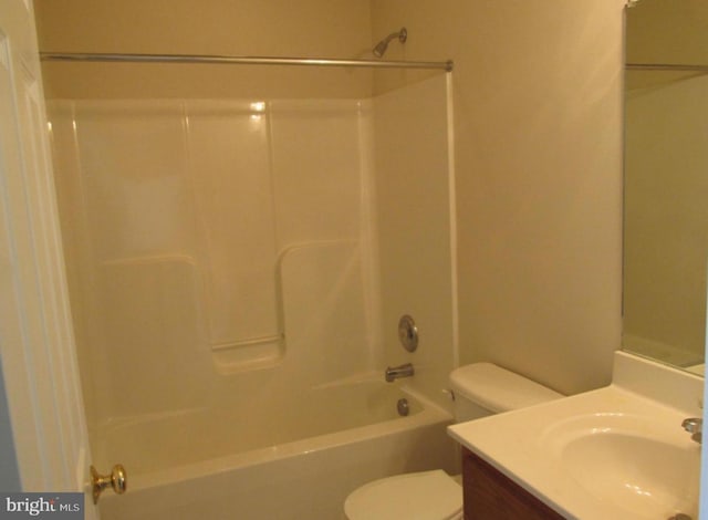 bathroom featuring shower / washtub combination, toilet, and vanity